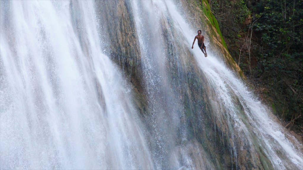 El Limon Falls featuring a waterfall as well as an individual male