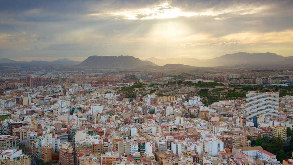 Castle of Santa Barbara which includes mountains, a city and a sunset