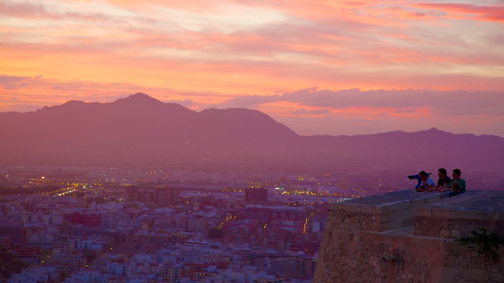 Castle of Santa Barbara showing a sunset, mist or fog and château or palace