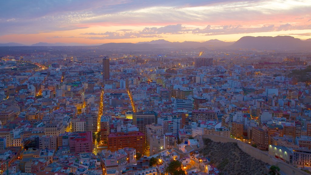 Castle of Santa Barbara featuring a city, mountains and a sunset