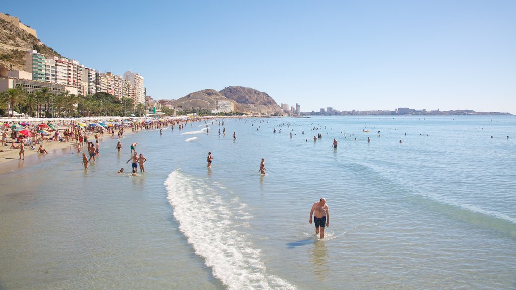 Postiguet Beach which includes swimming, landscape views and a coastal town