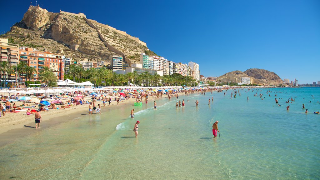 Postiguet Beach which includes swimming, a beach and a coastal town