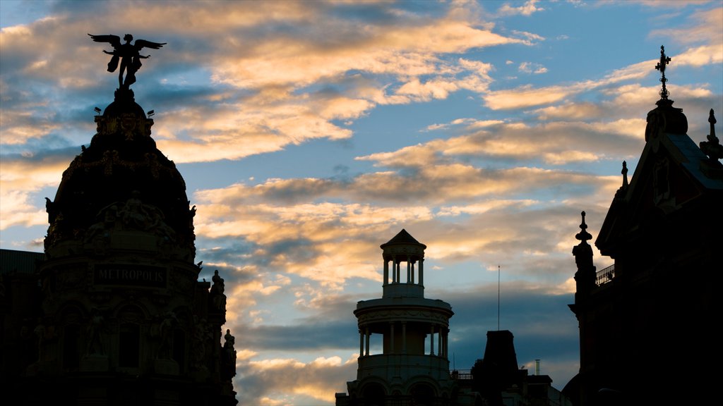 Gran Via which includes heritage architecture, a sunset and a church or cathedral