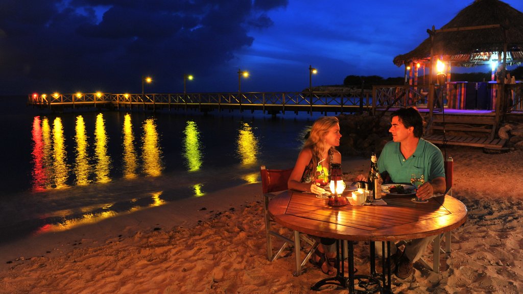 Willemstad showing a sandy beach, outdoor eating and night scenes