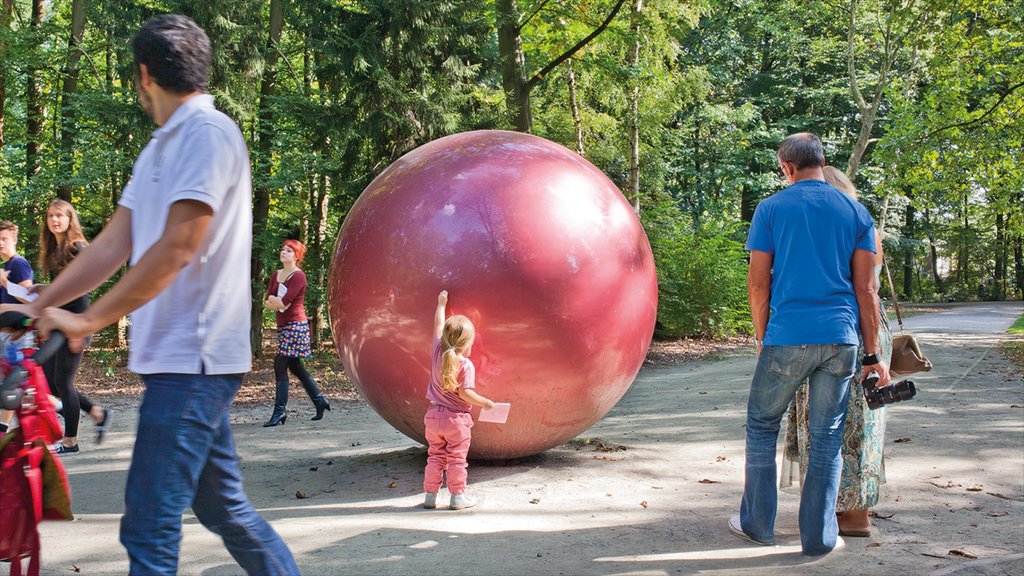 Middelheim Museum showing a park and outdoor art as well as a small group of people