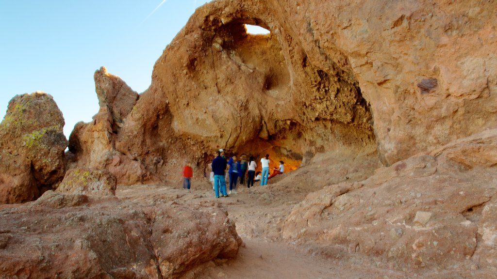 Hole in the Rock featuring caves, a gorge or canyon and hiking or walking