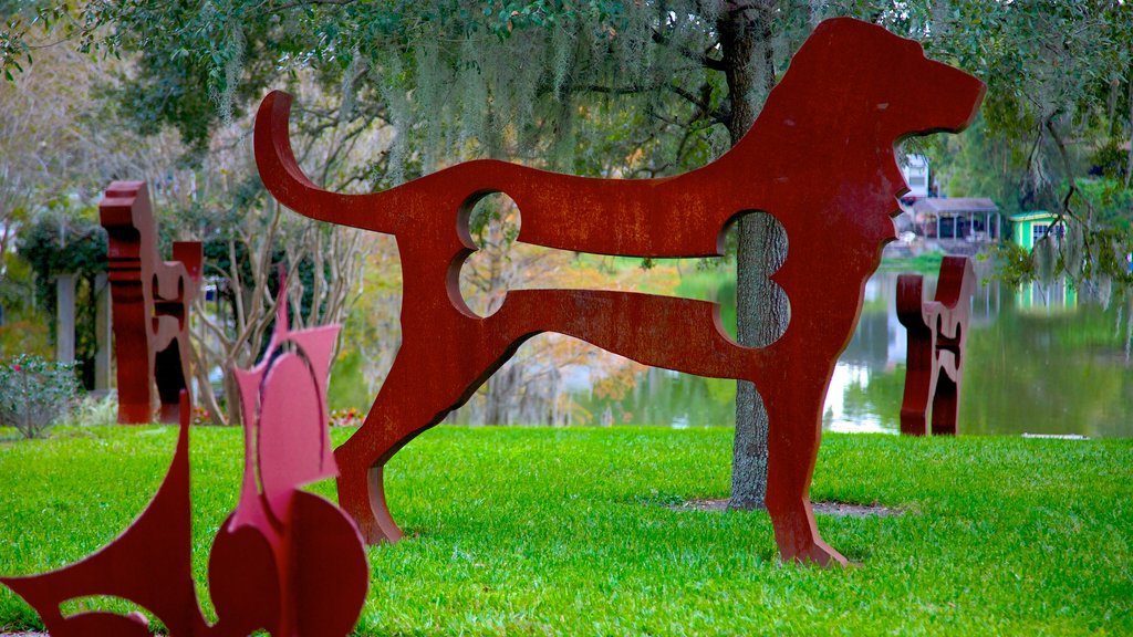 Loch Haven Park showing outdoor art, a garden and a pond