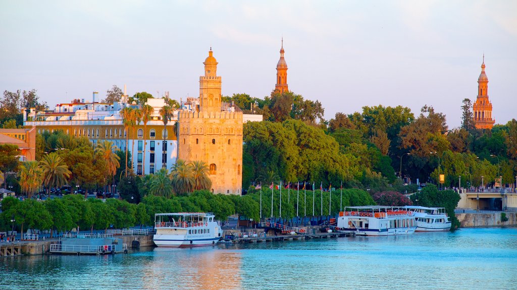 Torre del Oro Watchtower featuring heritage architecture, military items and a bay or harbor