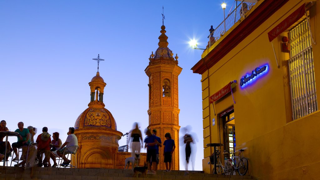 Triana Bridge which includes a church or cathedral, outdoor eating and religious aspects