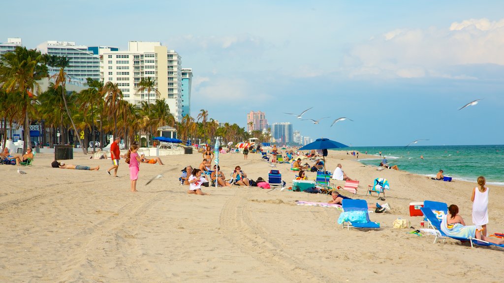 Fort Lauderdale Beach which includes a beach and a luxury hotel or resort as well as a large group of people