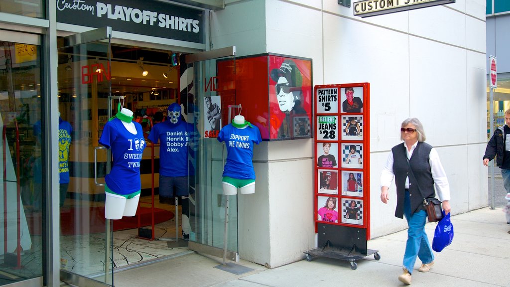 Robson Street featuring fashion, signage and street scenes