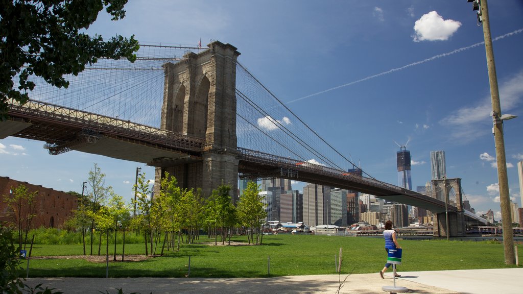 Brooklyn Bridge showing a park, a city and heritage architecture