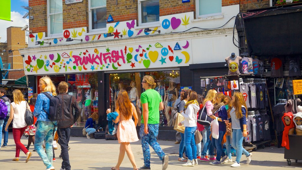 Camden Town featuring shopping and signage as well as a large group of people