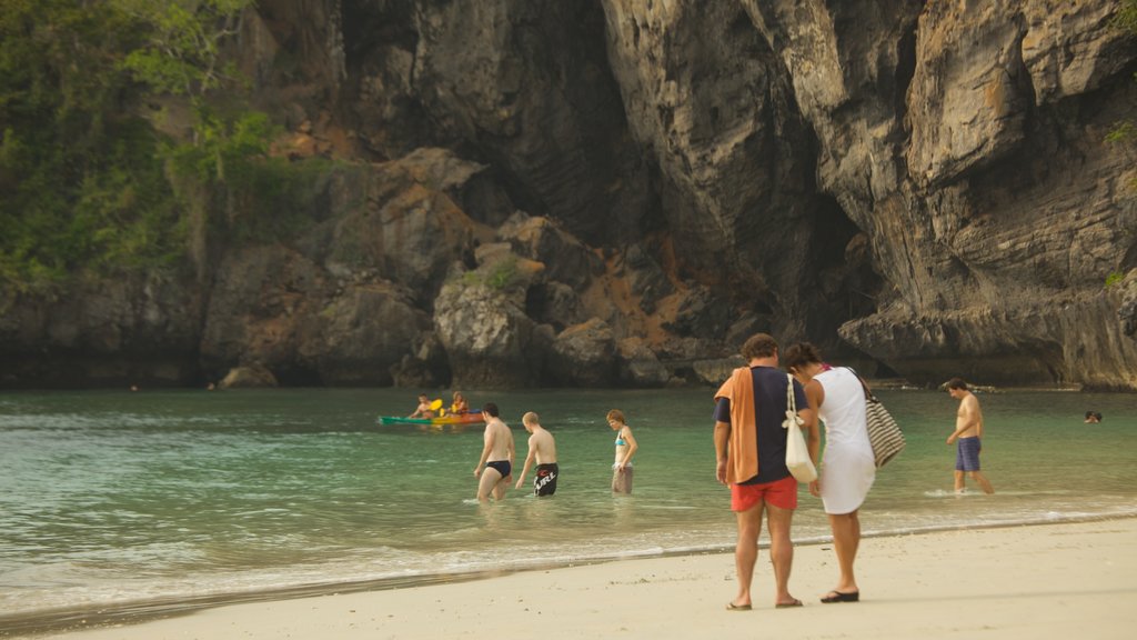 West Railay Beach showing swimming, a sandy beach and rugged coastline