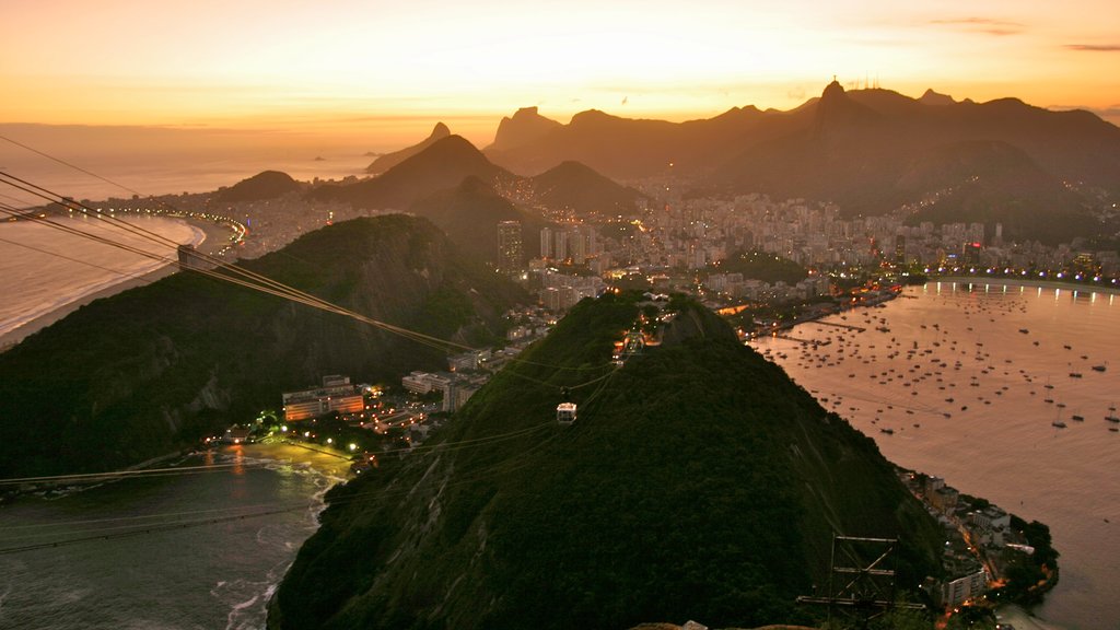 Sugar Loaf Mountain which includes a bay or harbour, a sunset and a coastal town