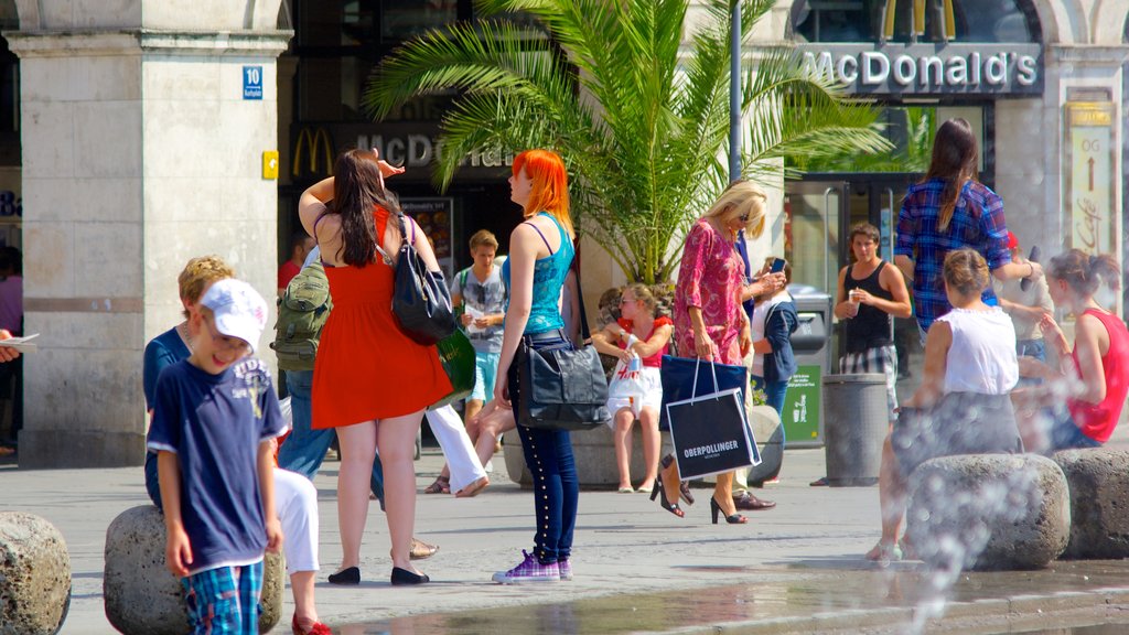 Karlsplatz - Stachus showing a city and street scenes as well as a large group of people