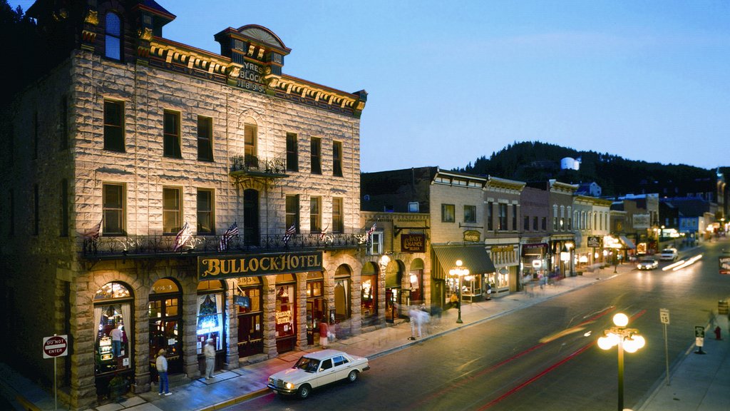 Deadwood which includes a hotel, night scenes and signage