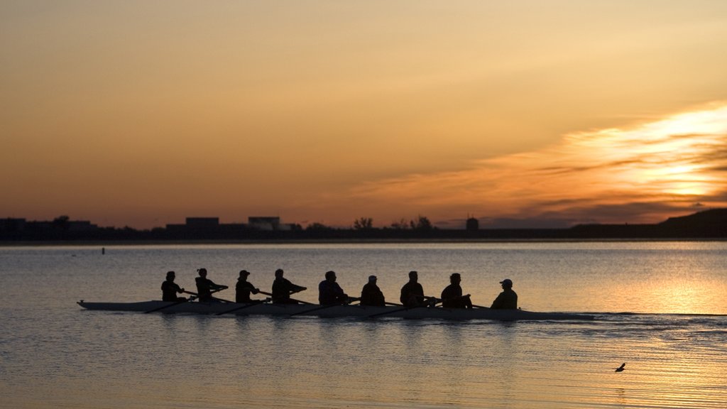 Boulder showing a sunset and kayaking or canoeing as well as a large group of people