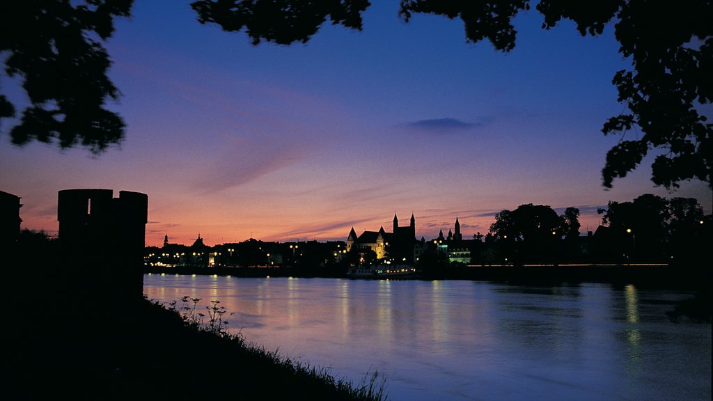 Maastricht showing night scenes, a city and a river or creek