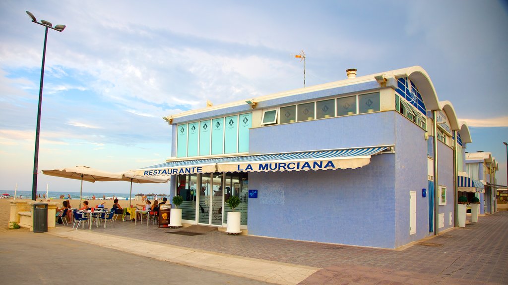 Malvarrosa Beach which includes street scenes, a sandy beach and outdoor eating