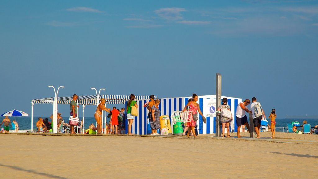 Malvarrosa Beach which includes a sandy beach as well as a large group of people