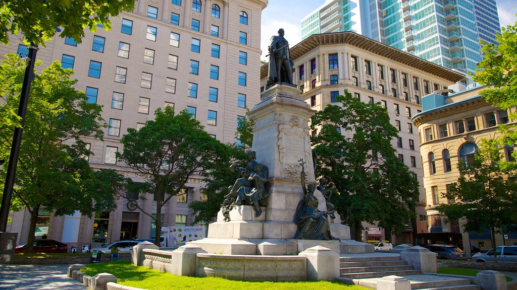 Downtown Montreal showing a square or plaza, a monument and a statue or sculpture