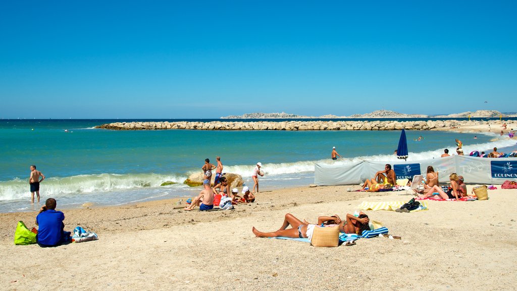 Borely Beach showing general coastal views and a beach as well as a large group of people