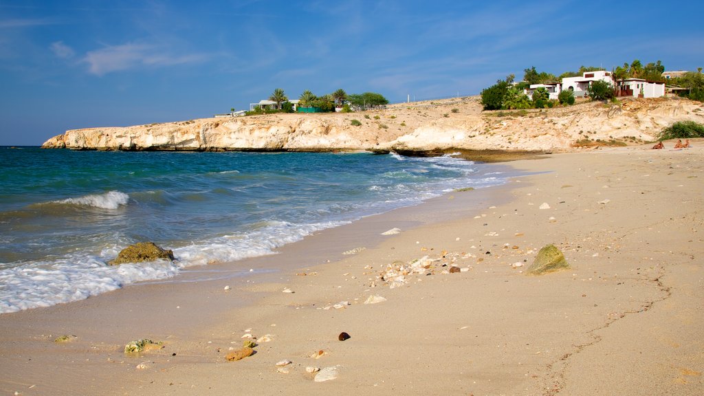 Shatti Al Qurum showing rocky coastline, a sandy beach and general coastal views