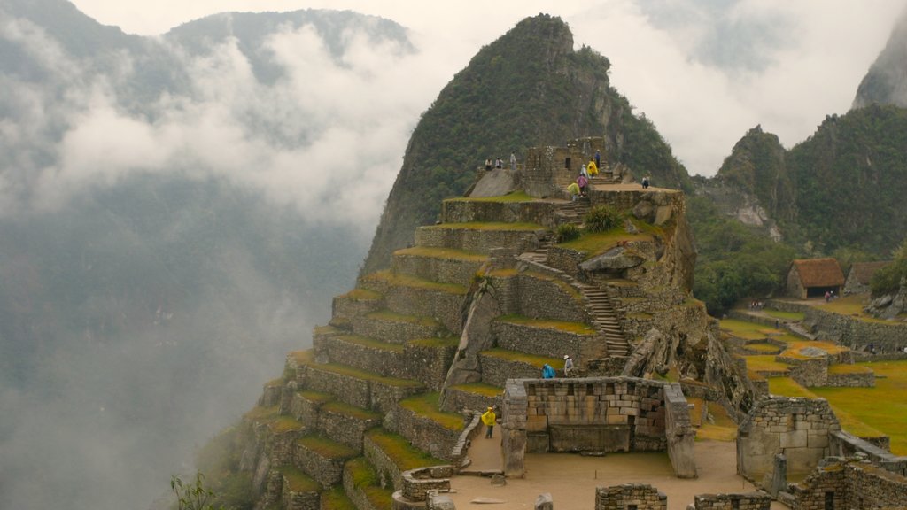 Machu Picchu showing mist or fog, a ruin and mountains