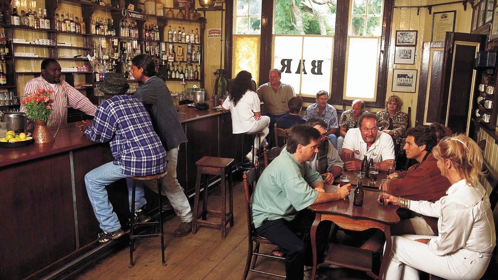 Pilgrims Rest featuring a bar and interior views as well as a large group of people