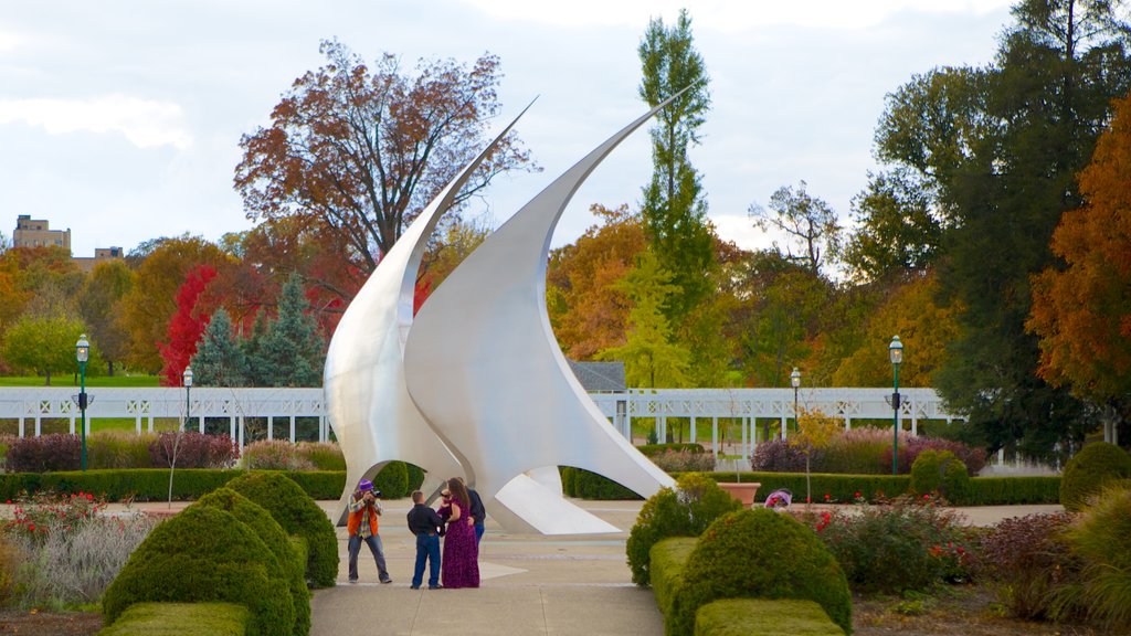 Franklin Park Conservatory which includes outdoor art and a park as well as a small group of people