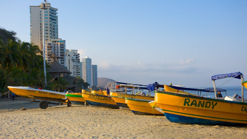 Rodadero Beach showing a sandy beach, a coastal town and boating