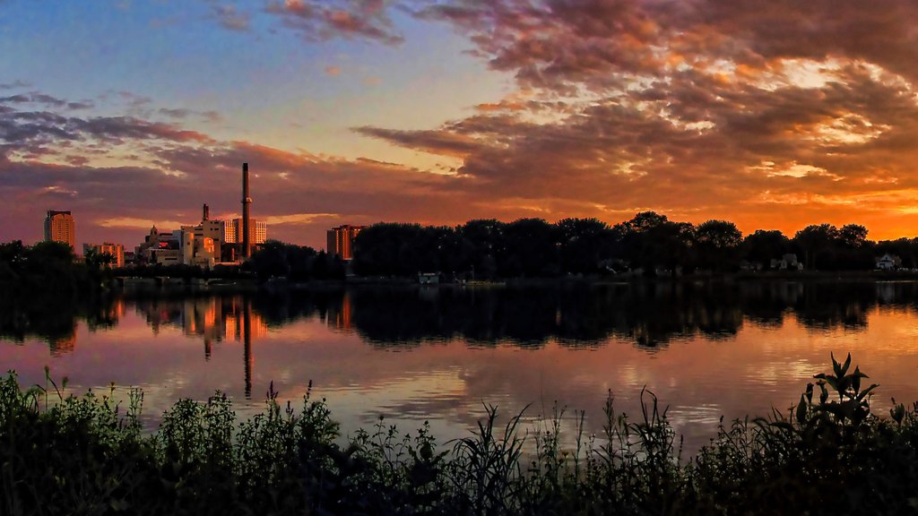 Rochester featuring a lake or waterhole, a sunset and a city