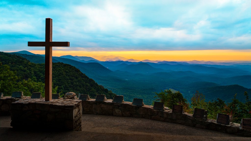 Greenville showing a sunset, religious elements and a monument