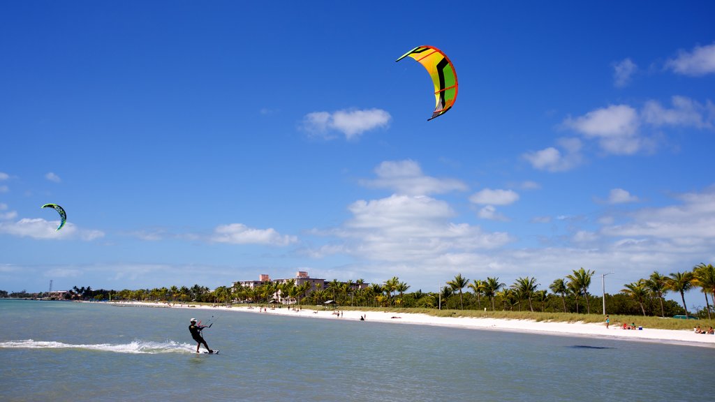 Smathers Beach featuring a beach and kite surfing as well as an individual male