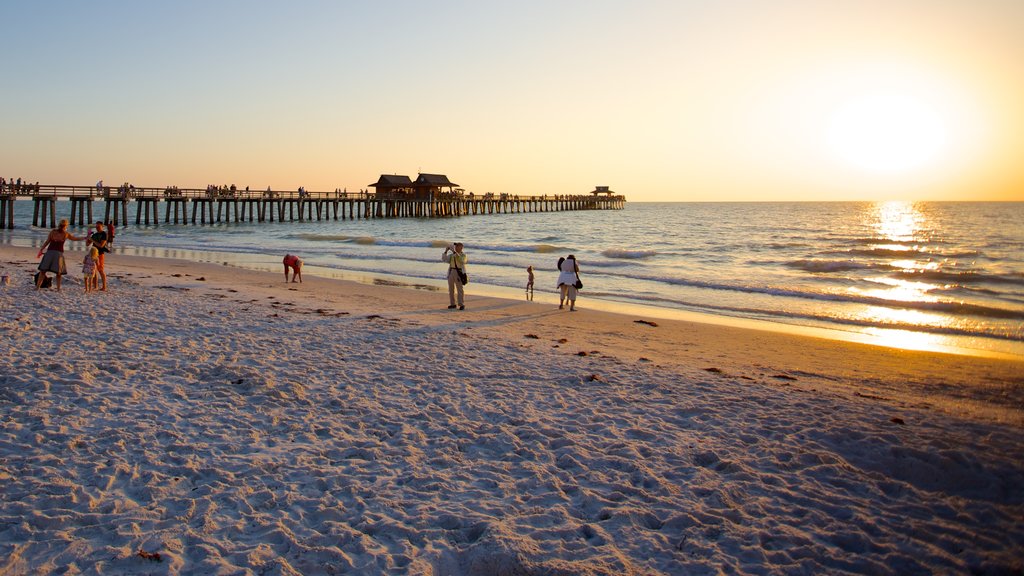 Naples Pier showing a beach and a sunset