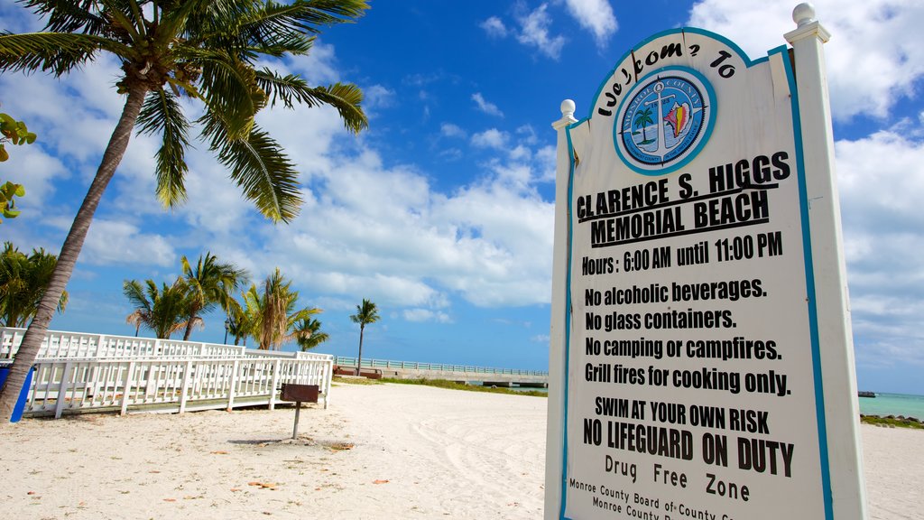 Higgs Beach showing signage and a sandy beach