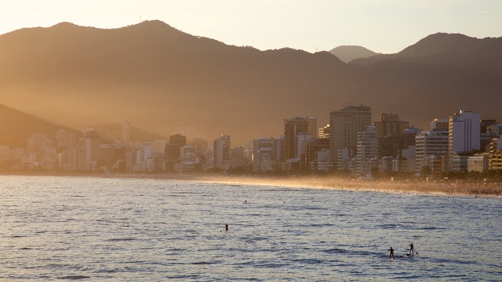 Río de Janeiro que incluye una puesta de sol, vistas generales de la costa y una ciudad