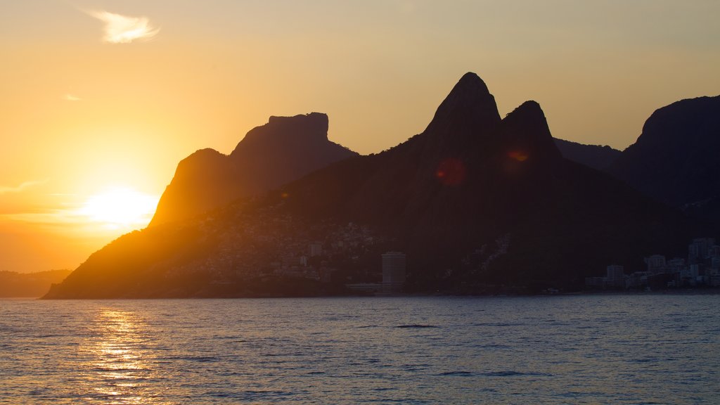 Arpoador Beach which includes a sunset, mountains and general coastal views