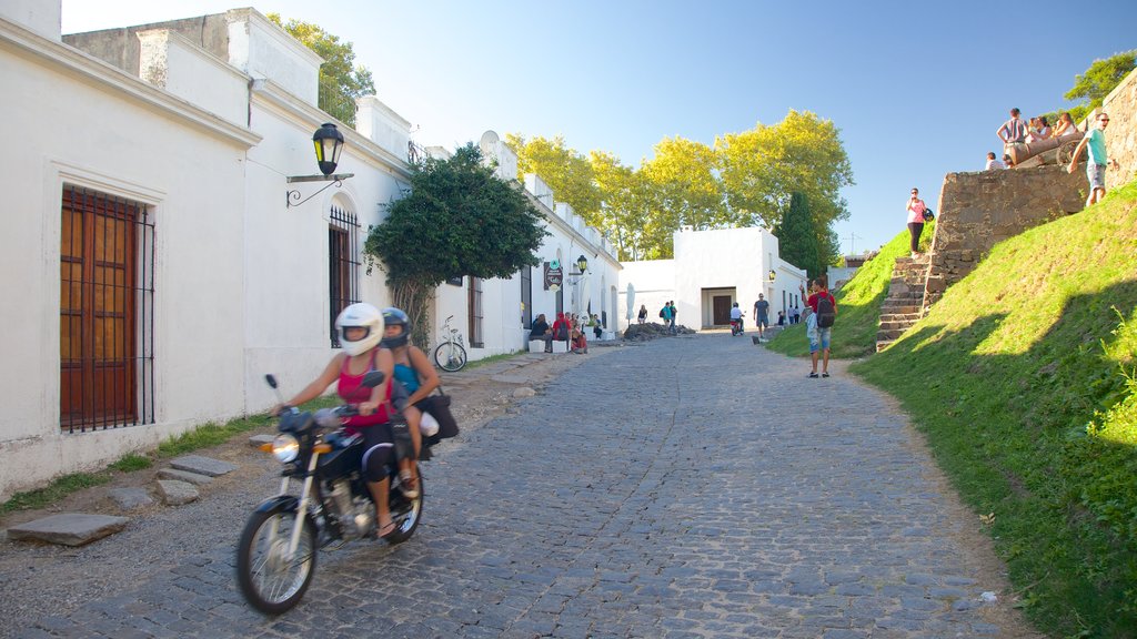 Porton de Campo featuring motorcycle riding and street scenes