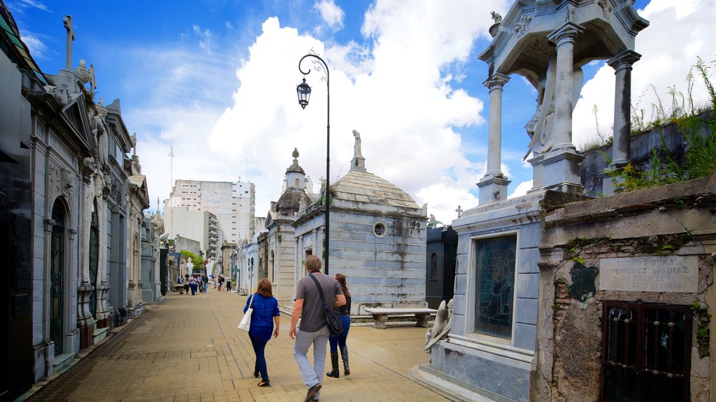 Recoleta Cemetery featuring a cemetery as well as a small group of people