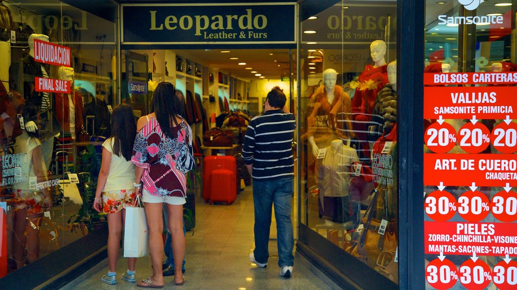 Florida Street featuring shopping and signage as well as a small group of people