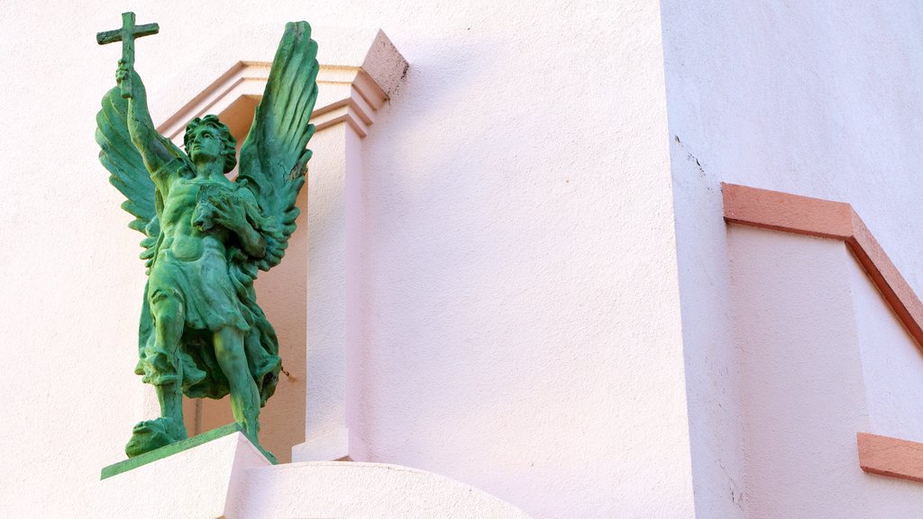 Mission San Rafael Arcangel featuring a statue or sculpture and religious elements