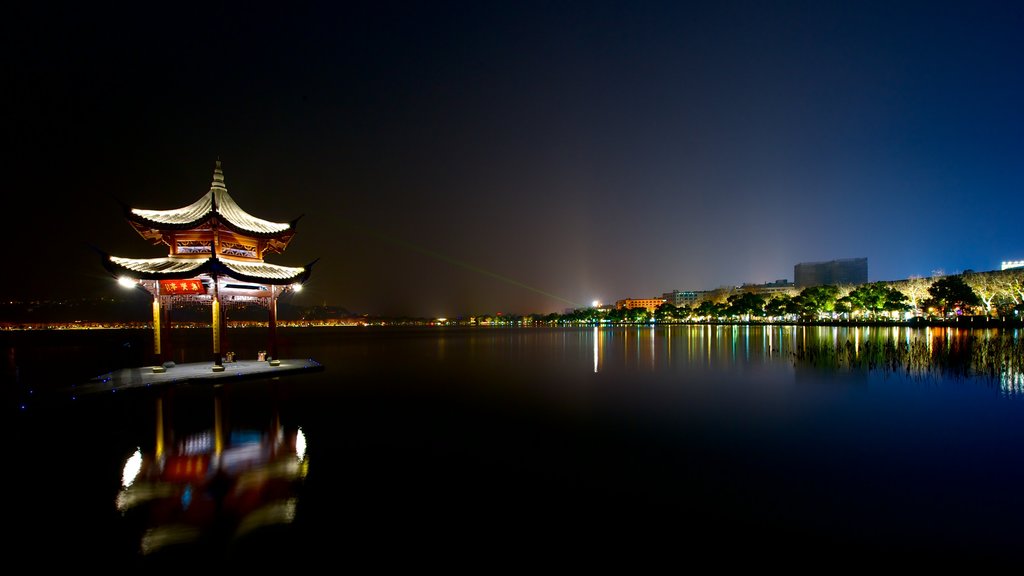 West Lake showing night scenes and a river or creek