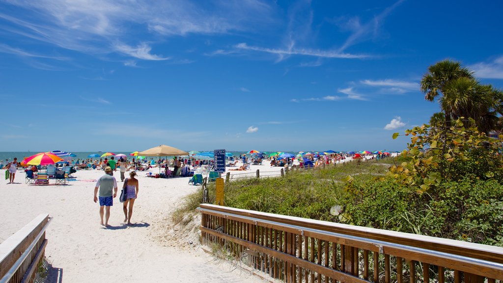 Fort Myers Beach which includes a sandy beach as well as a small group of people