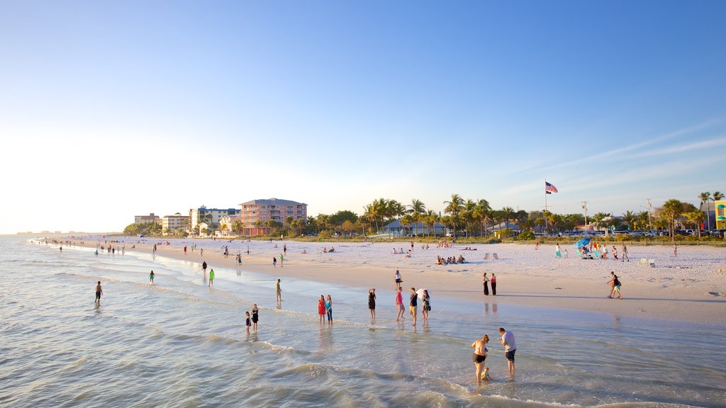 Fort Myers Beach showing a sandy beach and general coastal views as well as a large group of people