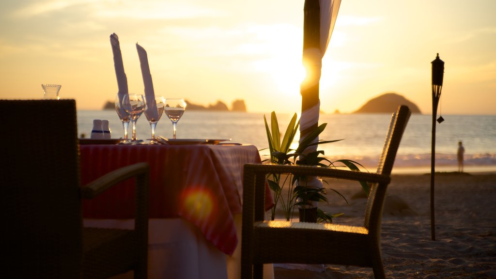 El Palmar Beach showing a sandy beach, a luxury hotel or resort and a sunset