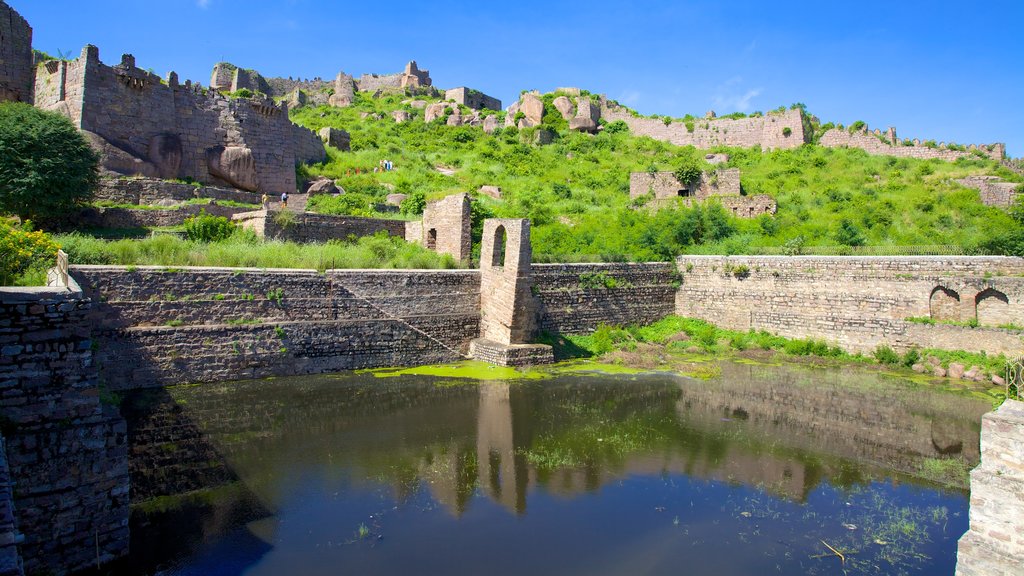 Golconda Fort showing building ruins and a pond