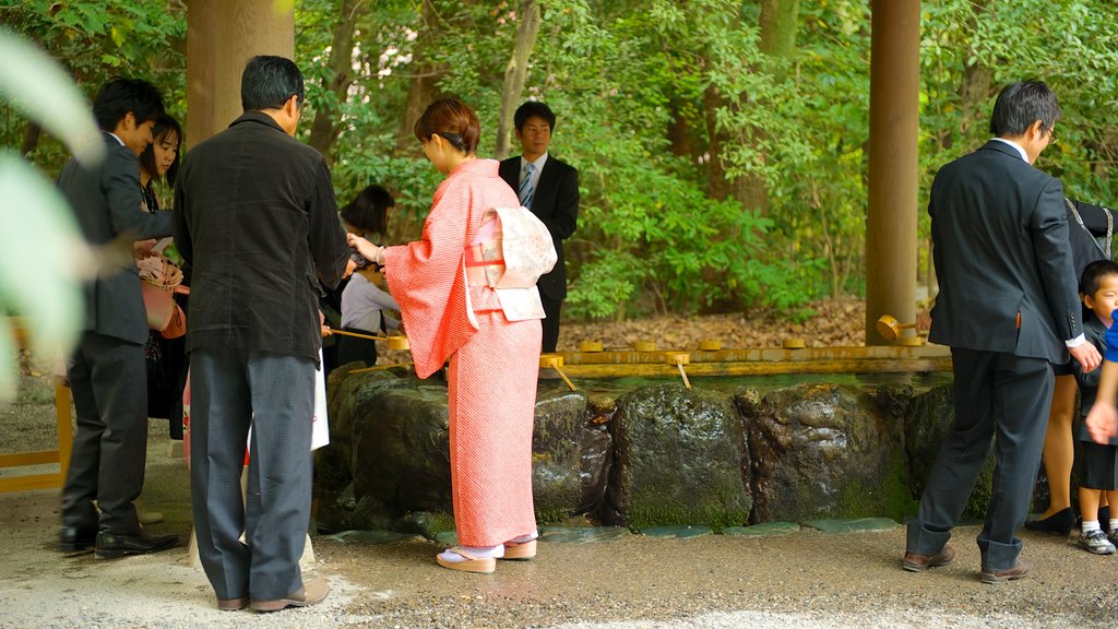 Atsuta Shrine featuring religious elements and a temple or place of worship as well as a large group of people