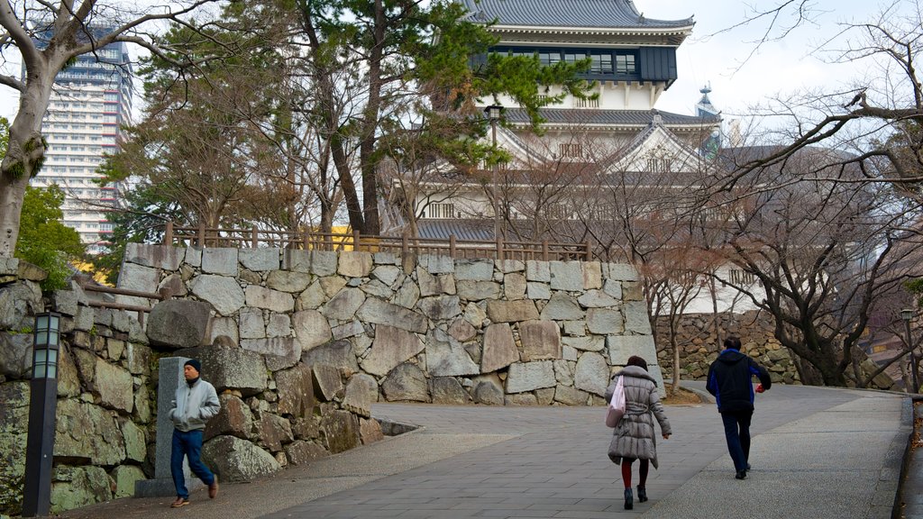 Kokura Castle featuring street scenes as well as a small group of people